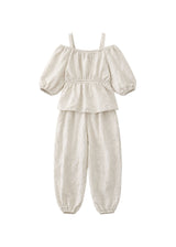 Off-Shoulder Peplum Jumpsuit in Linen in Natural — flat lay