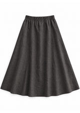 A-Line Paneled Skirt in ebony sandwashed linen, flat lay with gathered elastic waistband and vertical panel seams.