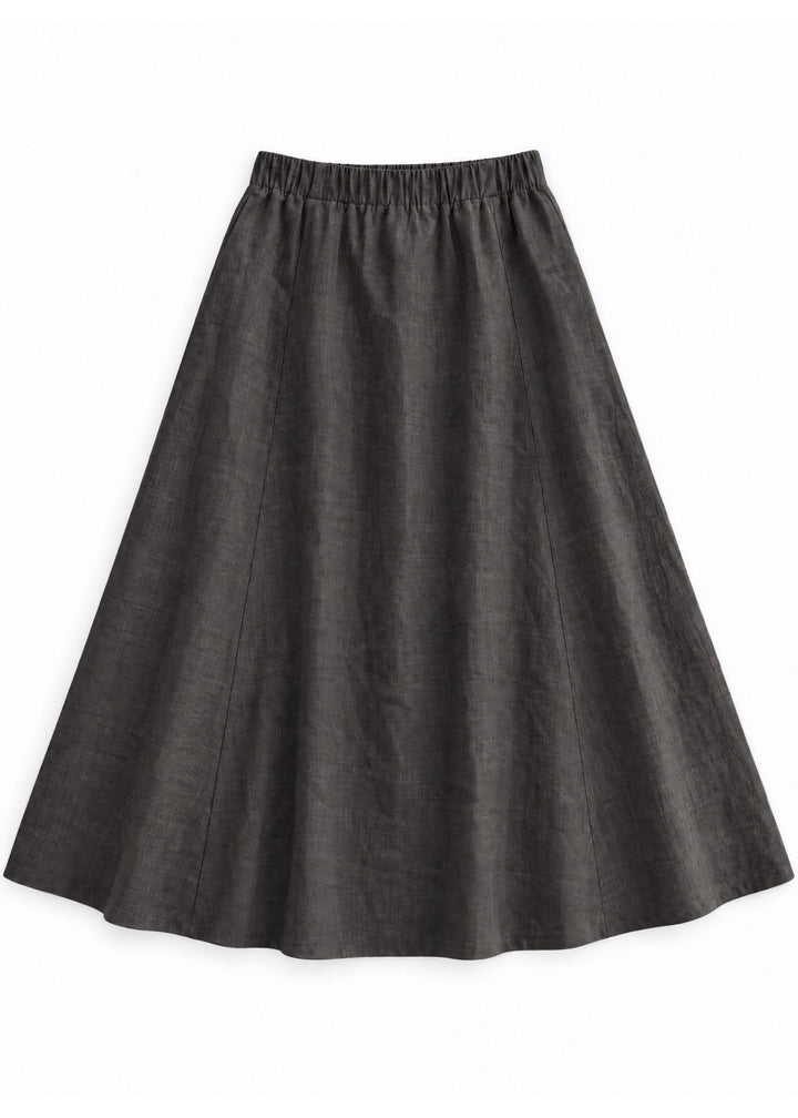 A-Line Paneled Skirt in ebony sandwashed linen, flat lay with gathered elastic waistband and vertical panel seams.