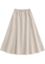 A-Line Paneled Skirt in natural sandwashed linen, flat lay with gathered elastic waistband and vertical panel seams.