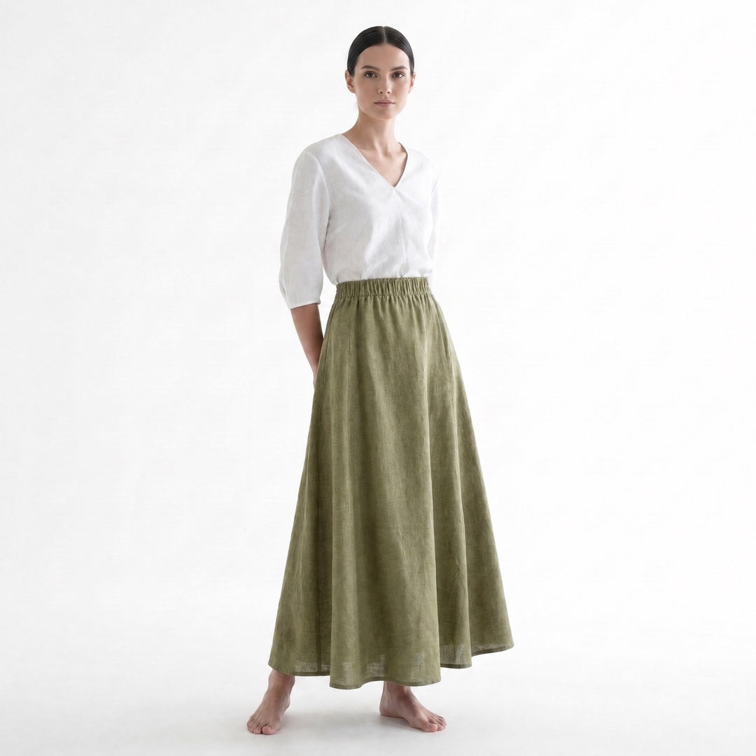 Woman in the olive A-Line Paneled Skirt with an elastic waistband and a white V-neck top.