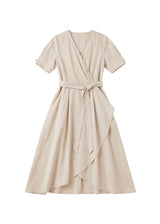 Beige adjustable wrap front dress with short sleeves and a tie waist.