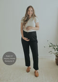 Model wearing the Adjustable Dress Pant in Ebony — cotton/wool maternity dress pant with tapered leg
