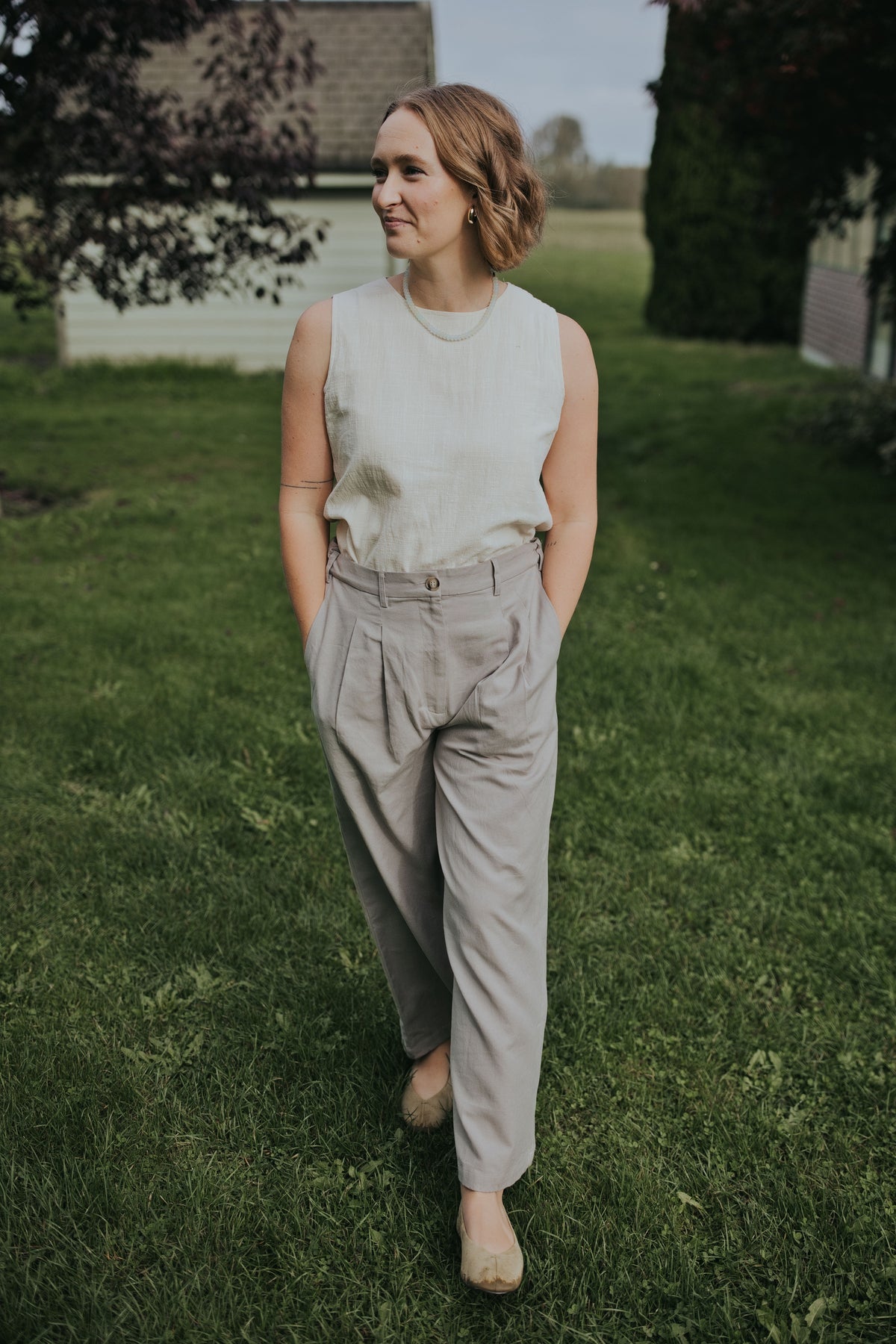 Close front view of the Gray Adjustable Wide Leg Dress Pant showing the pleats and button waistband