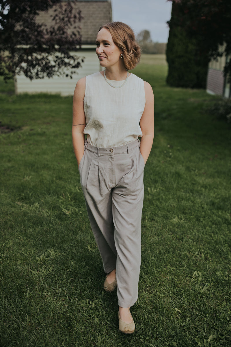 Close front view of the Gray Adjustable Wide Leg Dress Pant showing the pleats and button waistband
