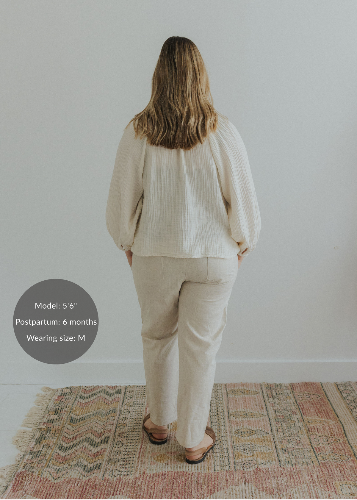 Back view of model wearing Everyday Transitional Smocked Linen Pants in natural beige.