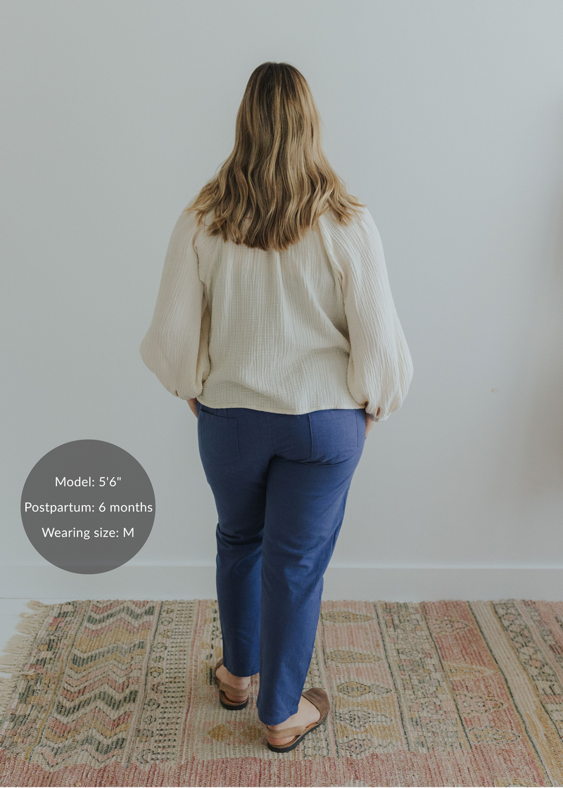 Woman from behind wearing Everyday Transitional Smocked Linen Pants in blue with a cream blouse.