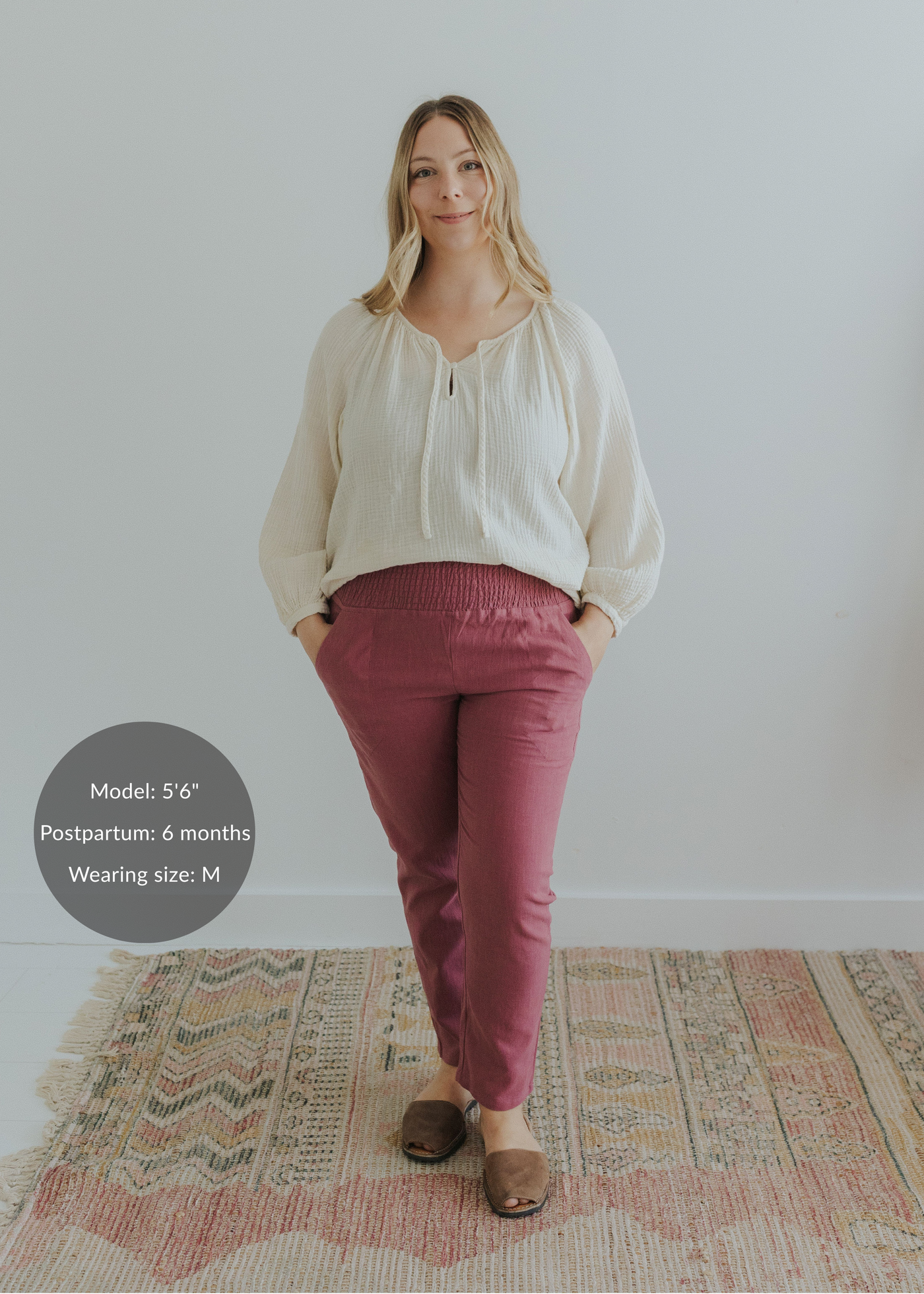 Woman wearing Everyday Transitional Smocked Linen Pants in berry, paired with an off-white blouse.