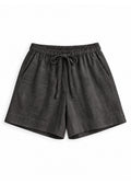 Drawstring Shorts in ebony sandwashed linen, flat lay.