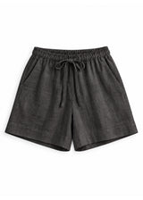 Drawstring Shorts in ebony sandwashed linen, flat lay.