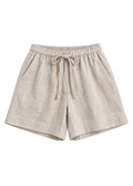 Drawstring Shorts in natural sandwashed linen, flat lay with elastic drawstring waist and side pockets.