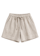 Drawstring Shorts in natural sandwashed linen, flat lay with elastic drawstring waist and side pockets.