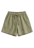 Drawstring Shorts in olive sandwashed linen, flat lay.