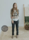 Woman wearing dark gray Dressy Stretch Ponte Pants, a white top, and a plaid cardigan.
