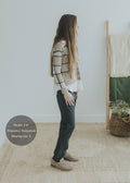 Woman in dark gray Dressy Stretch Ponte Pant, white top, and plaid cardigan.