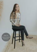 Smiling model wearing dark gray Dressy Stretch Ponte Pants with a contoured waistband and ankle-length design.