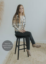 Smiling model wearing dark gray Dressy Stretch Ponte Pants with a contoured waistband and ankle-length design.
