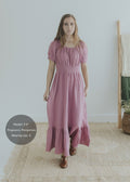 Woman in a pink organic cotton gauze Ella maxi dress with smocked waist and scoop neck.