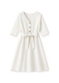 White linen Faye Dress with V-neck, front buttons, and a tied waist.