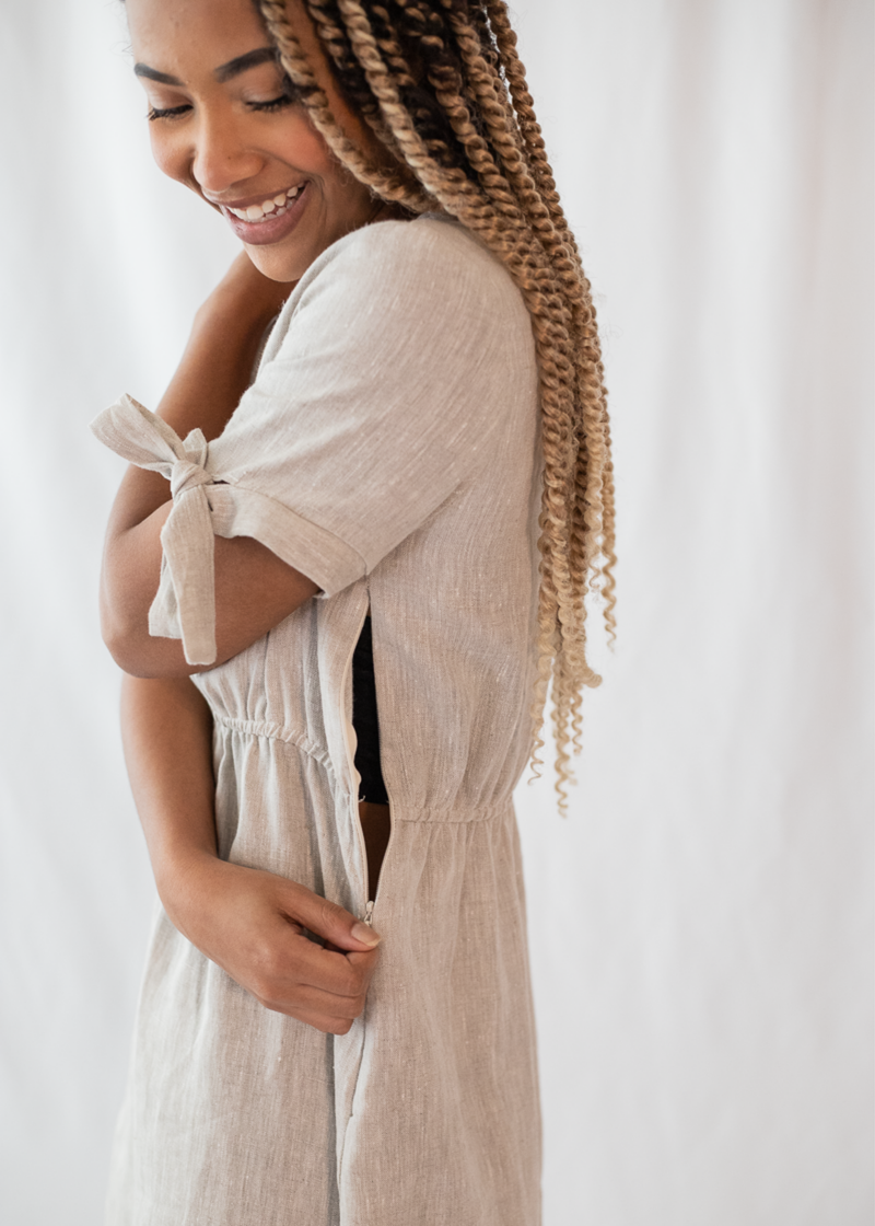 Smiling woman in a natural linen-cotton Florence Midi Dress with nursing access zipper and tied sleeves.