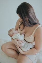 Woman holding her baby in the Beige Front Clasp Nursing Bra