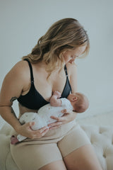 Woman holding her baby in the Ebony Front Clasp Nursing Bra