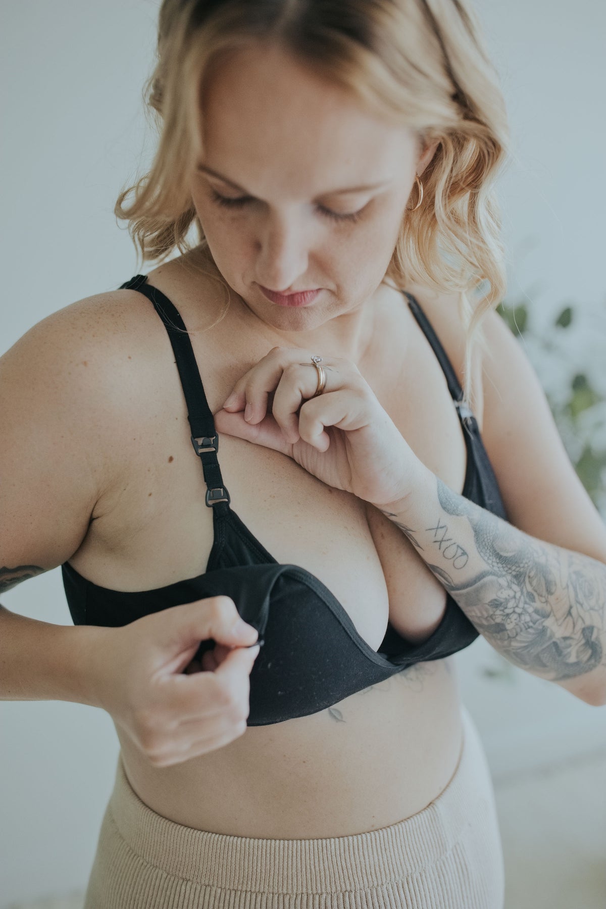 Woman unclipping the Ebony Front Clasp Nursing Bra one-handed to open the cup