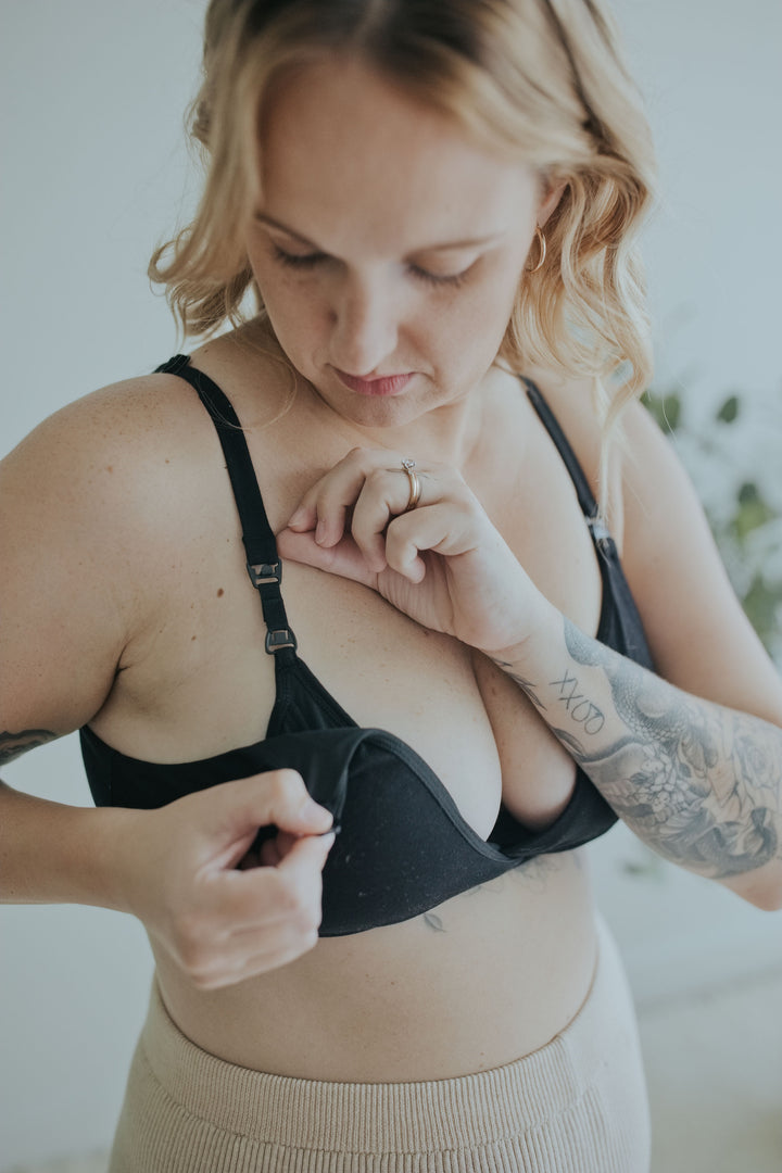 Woman unclipping the Ebony Front Clasp Nursing Bra one-handed to open the cup