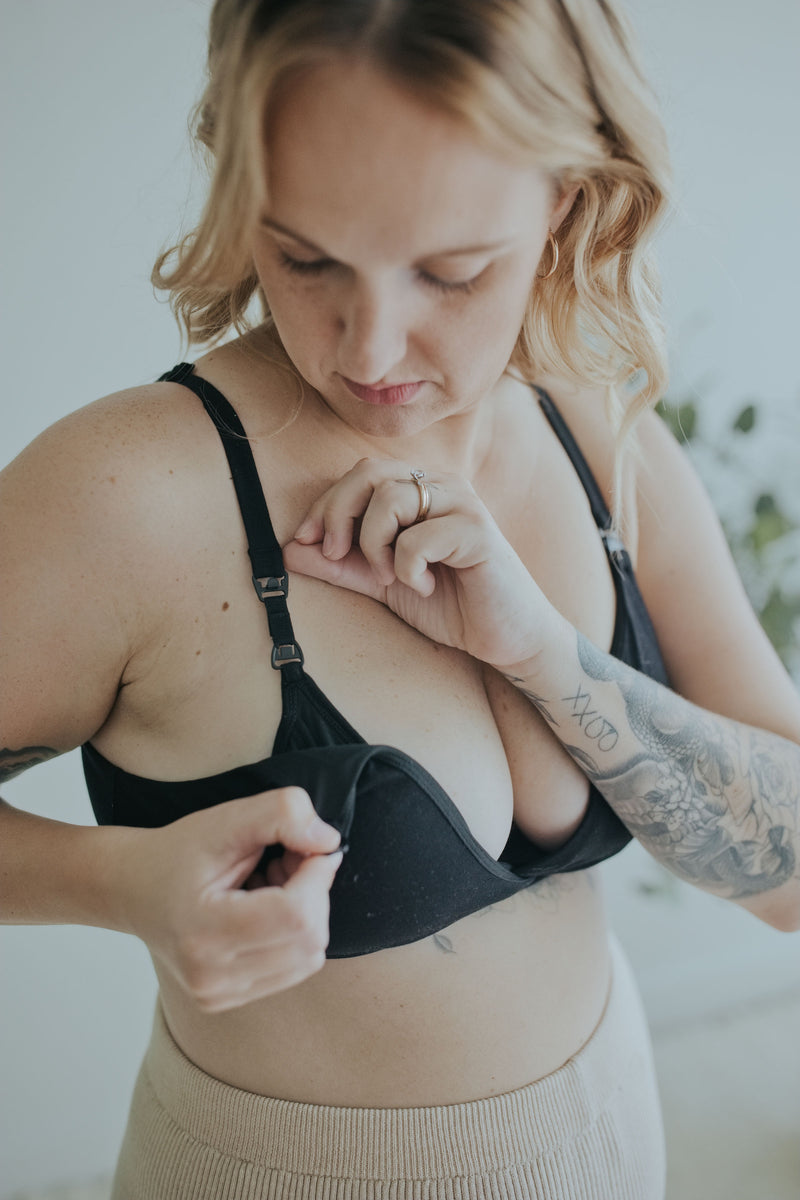 Woman unclipping the Ebony Front Clasp Nursing Bra one-handed to open the cup