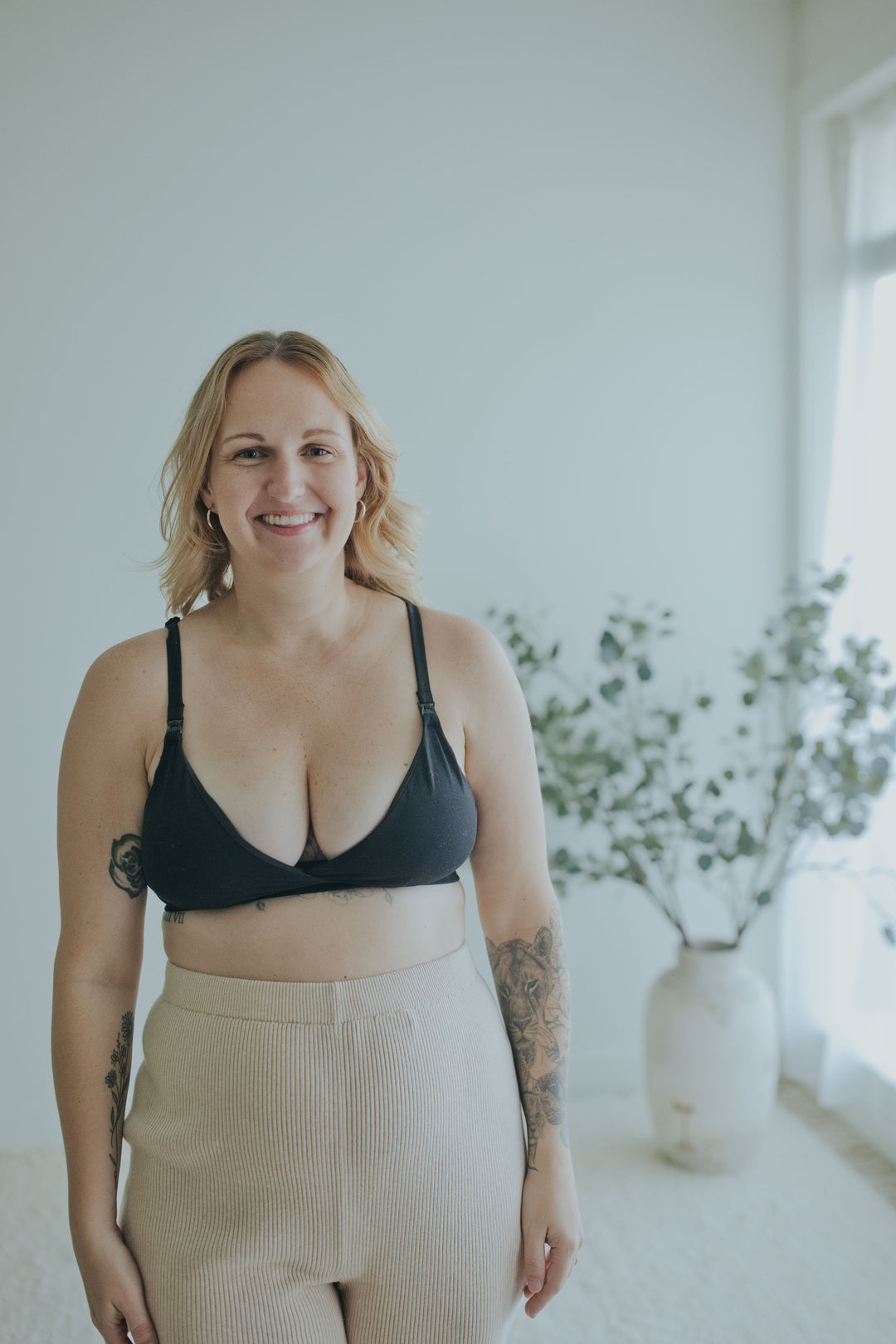 Woman in the Ebony Front Clasp Nursing Bra, closer front view showing the strap clips