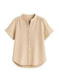 Oversized beige cotton gauze button-down top with short sleeves and a mandarin collar.