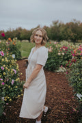 Three-quarter side view of the Beige Hazel Front Button Dress