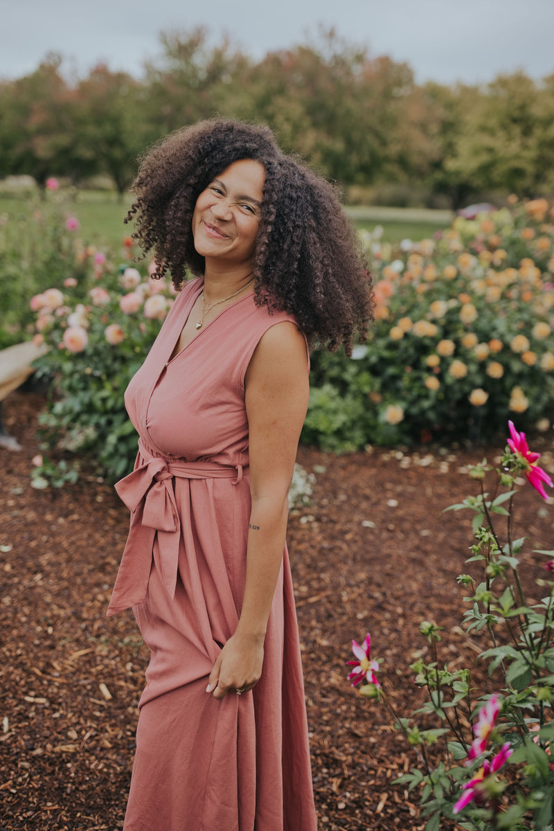 Close view of the Dusty Rose Iris Sleeveless Wrap Dress showing the wrap neckline and waist tie