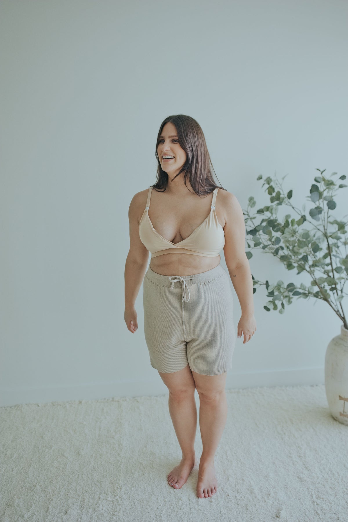 Smiling woman in the Mocha Knit Shorts with the Beige Front Clasp Nursing Bra