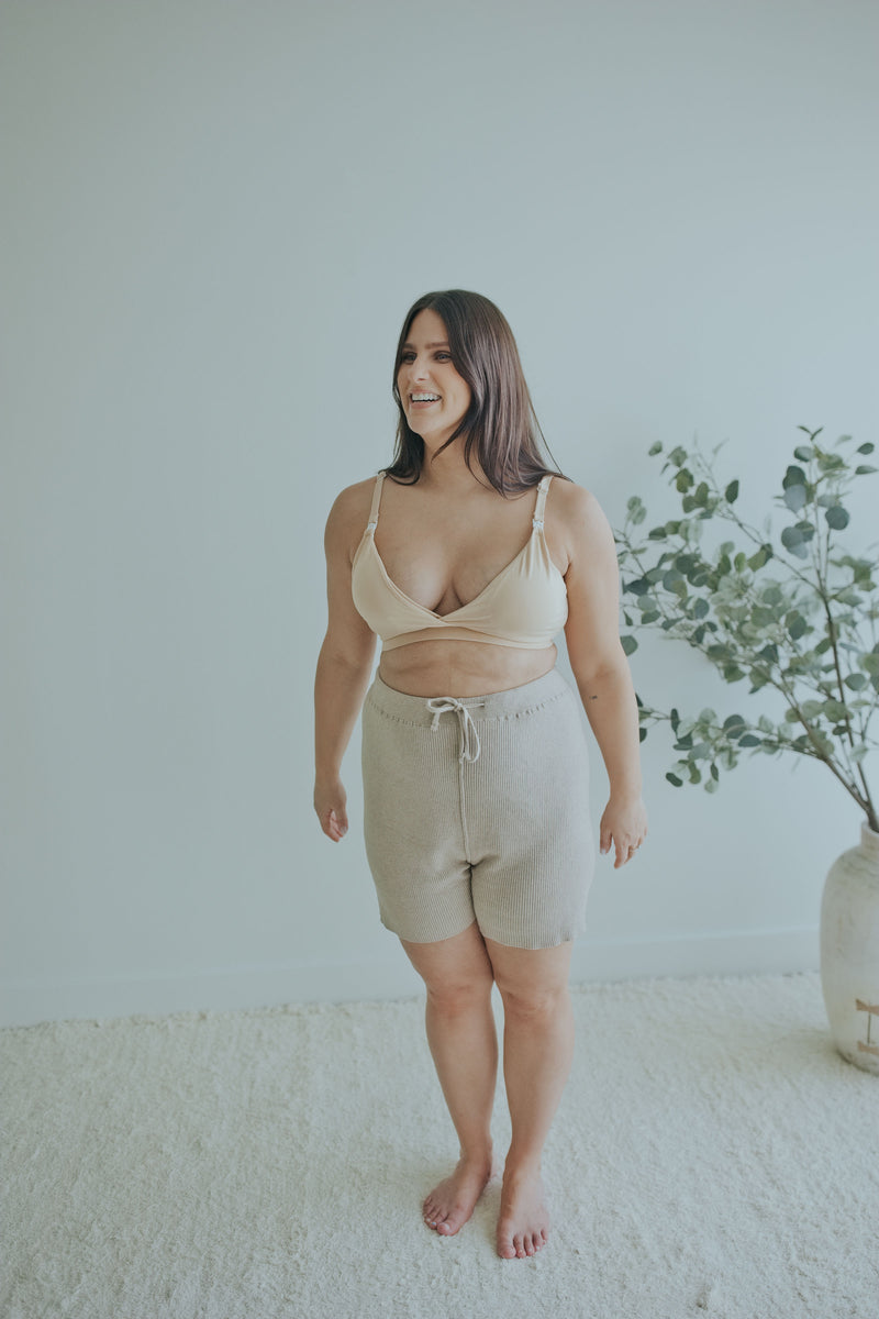 Smiling woman in the Mocha Knit Shorts with the Beige Front Clasp Nursing Bra
