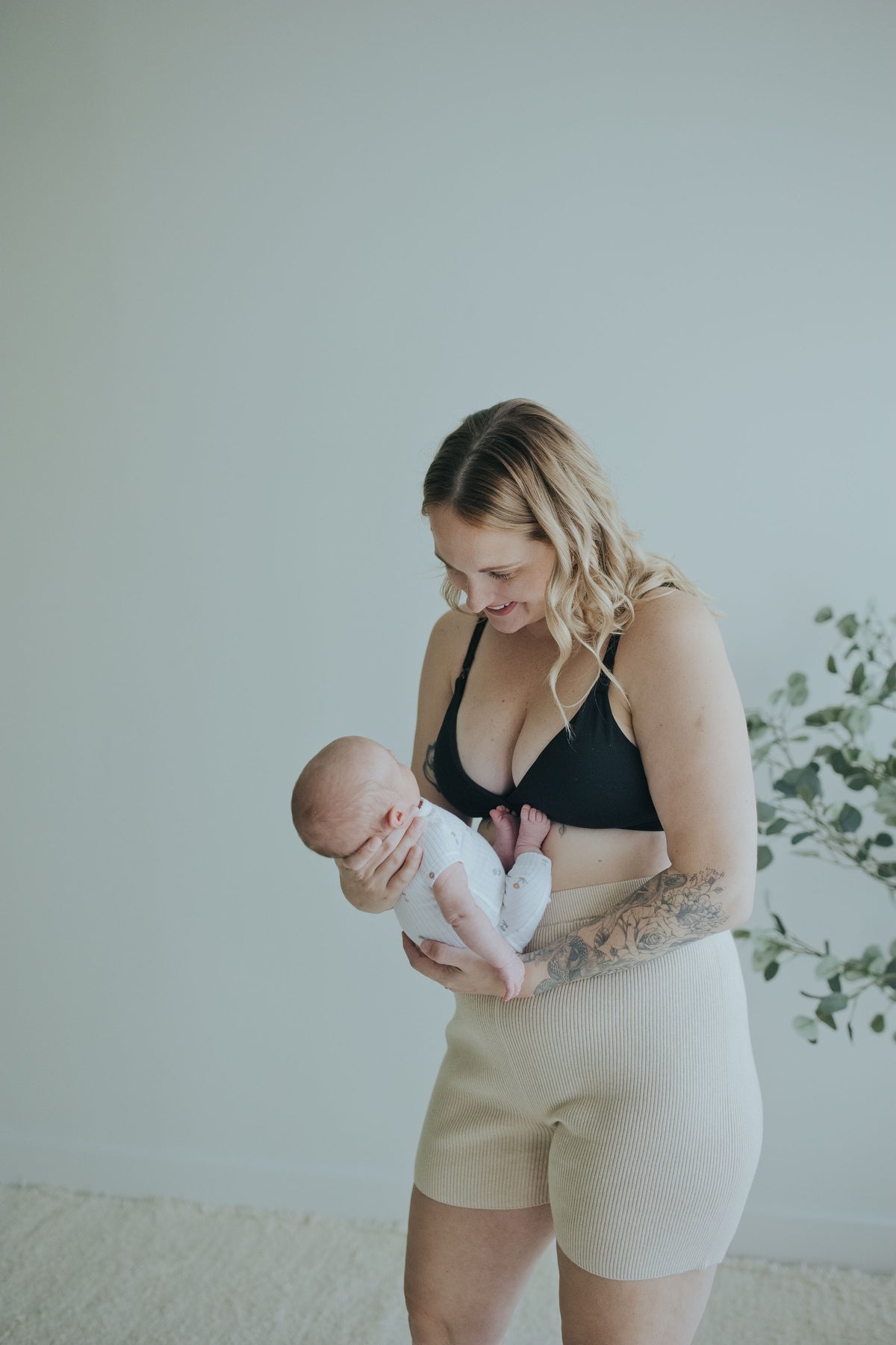 Mother holding her newborn in the Oatmeal Knit Shorts