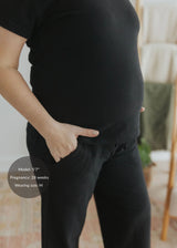 Pregnant model in a black cotton fleece lounge set, showing the relaxed fit and soft texture.