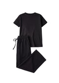 Black cotton fleece lounge set with a short-sleeve top and wide-leg pants with a drawstring waist.