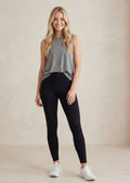 Smiling woman in black Fold Over Merino Leggings and a gray tank top.