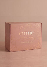 Pink Emme Mystery Box with gold leaf and dot design, "3 items: $200+ value" text.