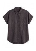 Nora Camp Shirt in ebony sandwashed linen, flat lay with point collar, chest pocket and cuffed short sleeves.