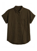 Nora Camp Shirt in olive sandwashed linen, flat lay with point collar, chest pocket and cuffed short sleeves.