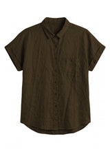 Nora Camp Shirt in olive sandwashed linen, flat lay with point collar, chest pocket and cuffed short sleeves.