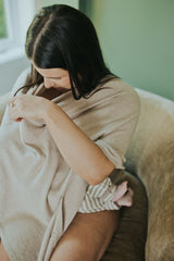 Mother nursing under the Mocha Nursing Cover