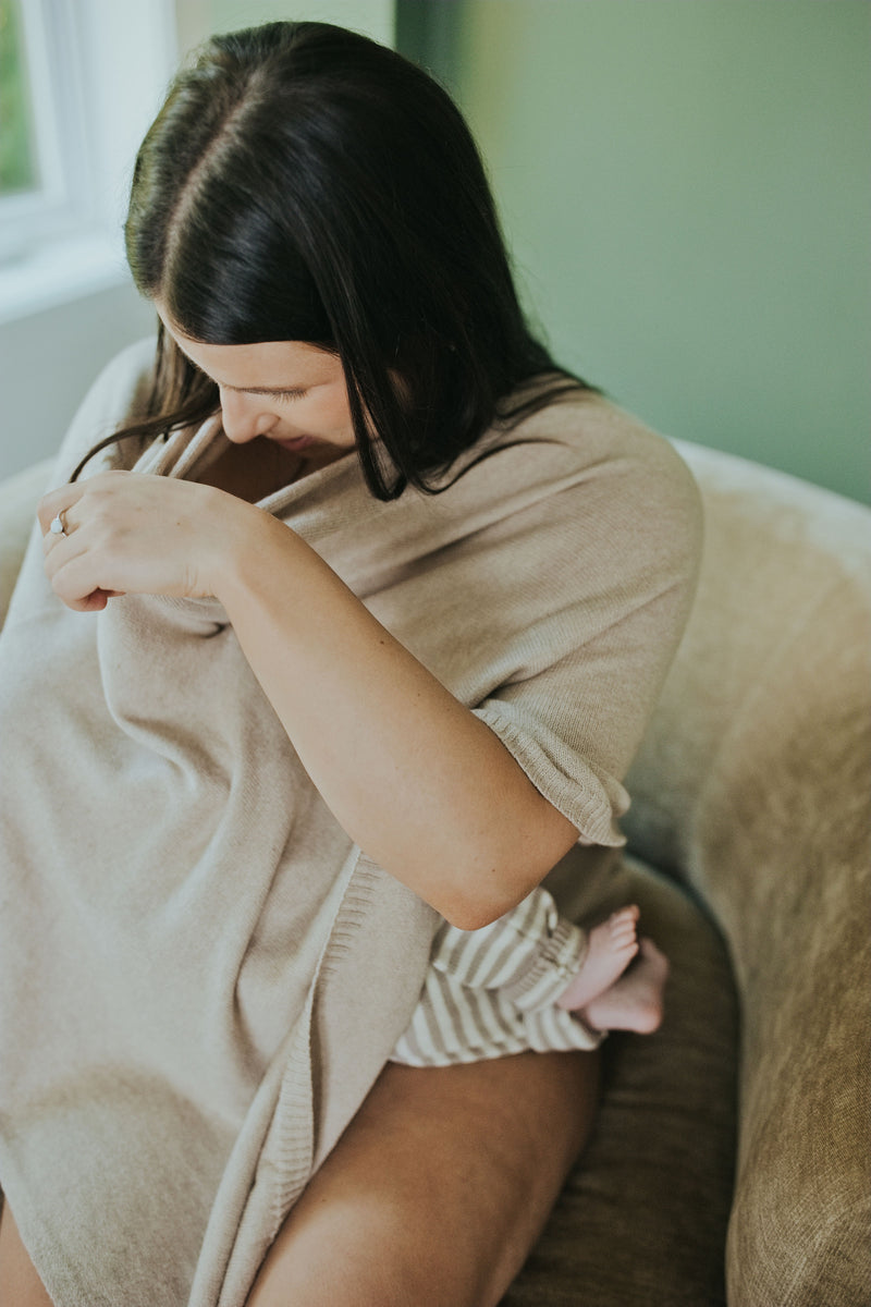 Mother nursing under the Mocha Nursing Cover