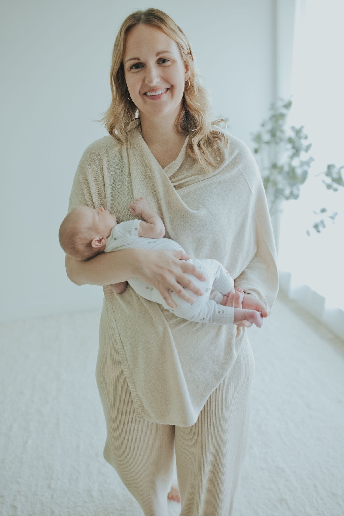 Mother holding her newborn in the Oatmeal Nursing Cover, front view