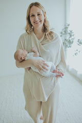 Mother holding her newborn in the Oatmeal Nursing Cover, front view