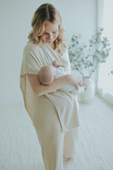 Mother nursing under the Oatmeal Nursing Cover, standing