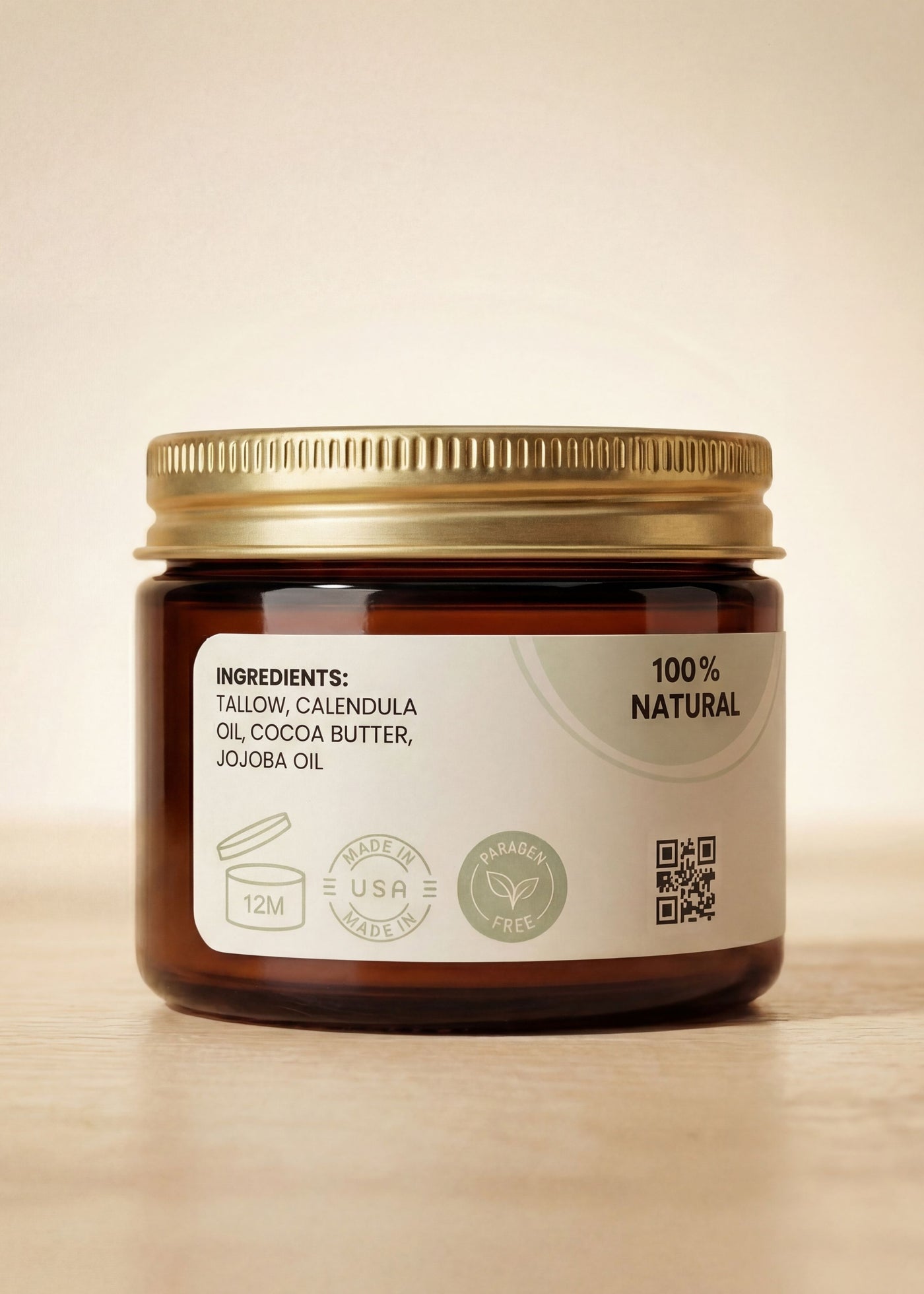 Amber glass jar of Nurturing Nipple Balm with gold lid, showing ingredients and "100% Natural" label.