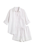 Oversized white linen co-ord set with a button-up shirt and drawstring shorts.